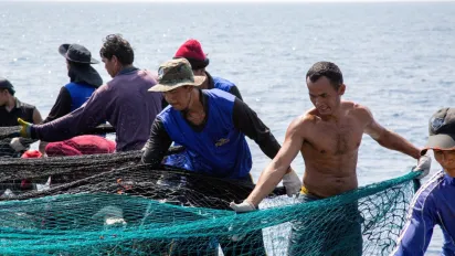 Cambodian migrant fishers set a trawl on a fishing vessel in Rayong, Thailand.