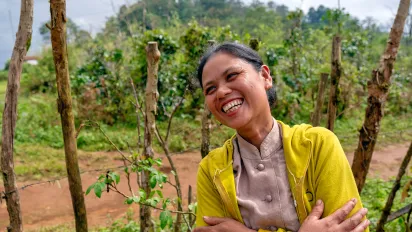 Smiling Laotian woman in a coffee plantation