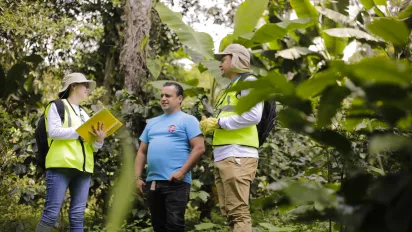 Woman labour inspector asking questions in a coffee plantation