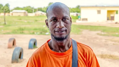 Diallo Koundja, an asylum seeker from Burkina Faso in northern Côte d'Ivoire, stands proudly facing the camera