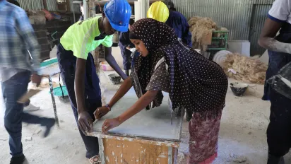 a young woman and a man attending training on woodwork in Ethiopia.