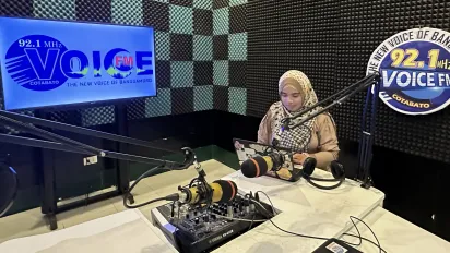 a woman wearing hijab in a radio station