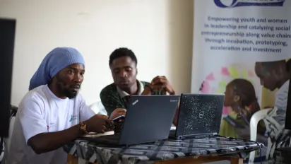 Two young men working on their laptops