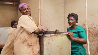 Three women producing shea butter.