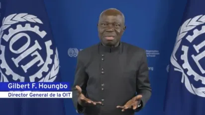 ILO Director-General Gilbert F. Houngo speaks to camera with ILO branding in the background.