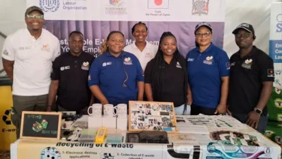 Smiling young workers at project stand