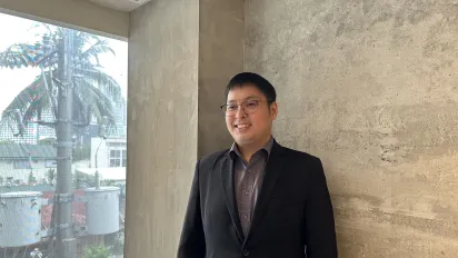 Engineer Joseph Daniel Bianes, a 32-year-old Associate Professor at the Polytechnic University of the Philippines standing and smiling.