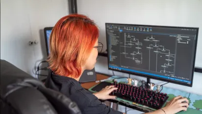 a woman using a desktop computer
