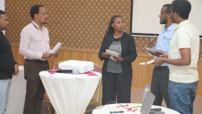 Participants actively interacting in a role play.