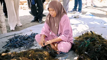 A woman seaweed farmer sorts harvested seaweed during a field visit in Ujung Baji Village, Takalar, South Sulawesi.