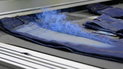 Denim jeans undergoing a finishing process at Eroğlu Manufacturing Studio in Ismailia, Egypt.