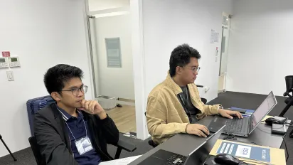 Two male participants using the Building Information Modeling on their computers.