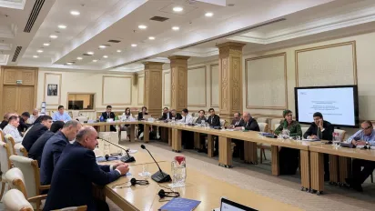 People sitting around U-shaped conference table