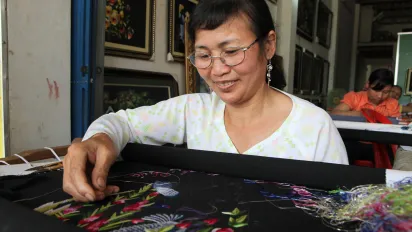 A woman at work during an embroidery workshop