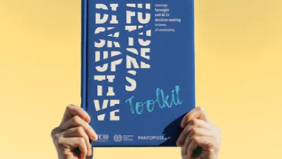 Disruptive Futures Toolkit book held in front of a yellow background.