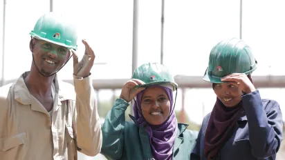 students of technical schools wearing helmets smiling