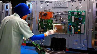 Woman worker on an electronic machinary