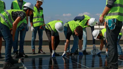 a group of workers lifting a panel for solar system