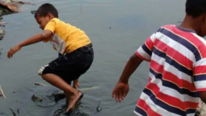 2 boys trudging through the mud