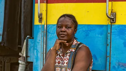 Woman sitting in front of a painted train