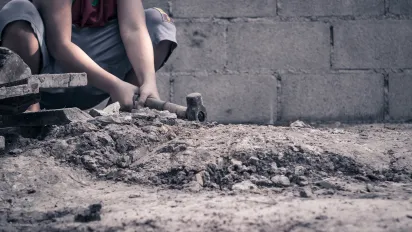 Young boy works in construction