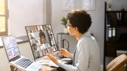 Woman working on a laptop in a virtual telework webinar