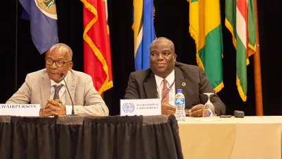 Two men with microphones sitting at a table