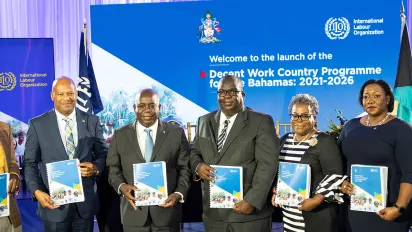 Seven people standing with documents in their hands