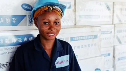 Better jobs for women: for 1 US$ a day, Grace cleans the windows of a building under construction on the seaside of Dar Es Salaam.