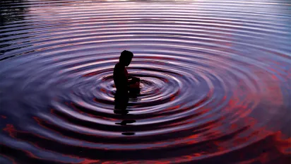 a fisher in water ripples
