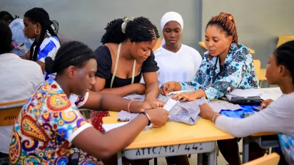 Five women working on a group assignment