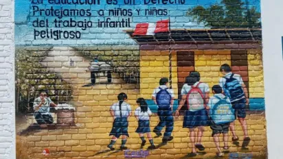 Mural painting depicting children going to school with a message on children's rights