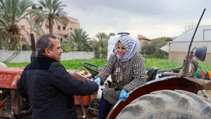a woman shaking hands with a man