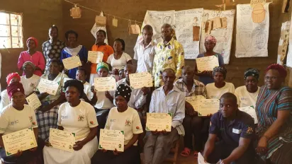Community members pose with their commitment certificates 