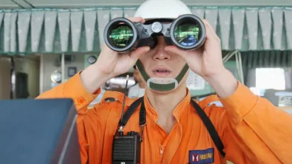 Worker looking through binoculars