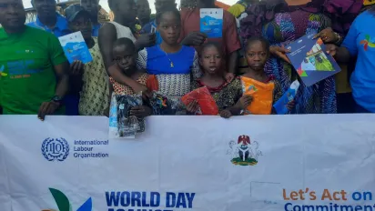Children hold a banner of the world day against child labour