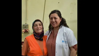 Two women, next to each other, smiling