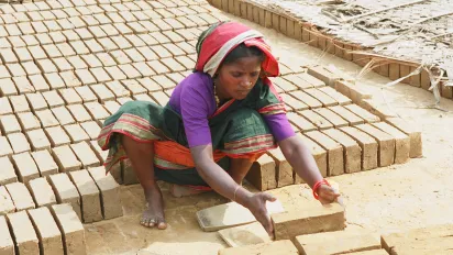 Woman manipulating bricks, Mangalore, India.