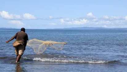 fisherman throwing his fishing net 