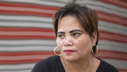A Philippino domestic worker woman stares into distance