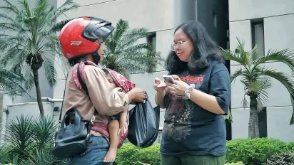 Natalia brings her baby to work as a food delivery. 