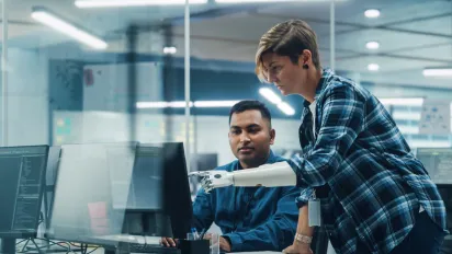 Woman with disability working on computer with prosthetic arm