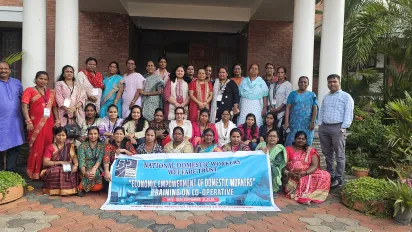 Men and women standing together with the event banner