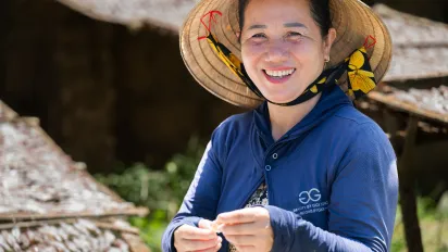 woman from Asia and the Pacific region smiling in a field