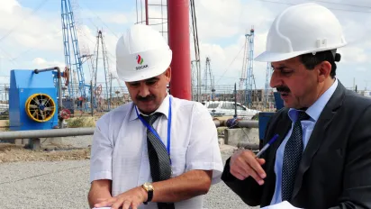 Azerbaijan country portal hero image two men discuss documents at a construction site