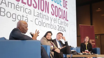 ILO Director-General sits in a panel on the stage