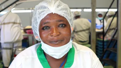A young woman worker at the EcoCajou factory smiles at the camera. She is a beneficiary of the ILO ProAgro YOUTH project, smiles at the camera in Odienné, Côte d'Ivoire, on 17 September 2024.