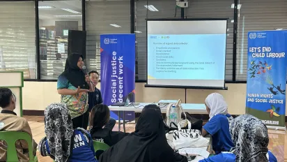 woman in hijab speaking at a child labour digital monitoring workshop