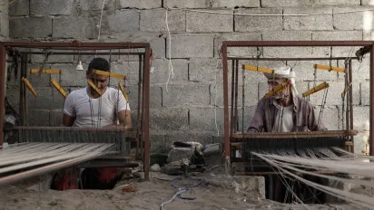 two men working with cloth
