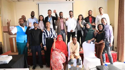 A group of young Ethiopians and ILO partners standing and sitting for a photo